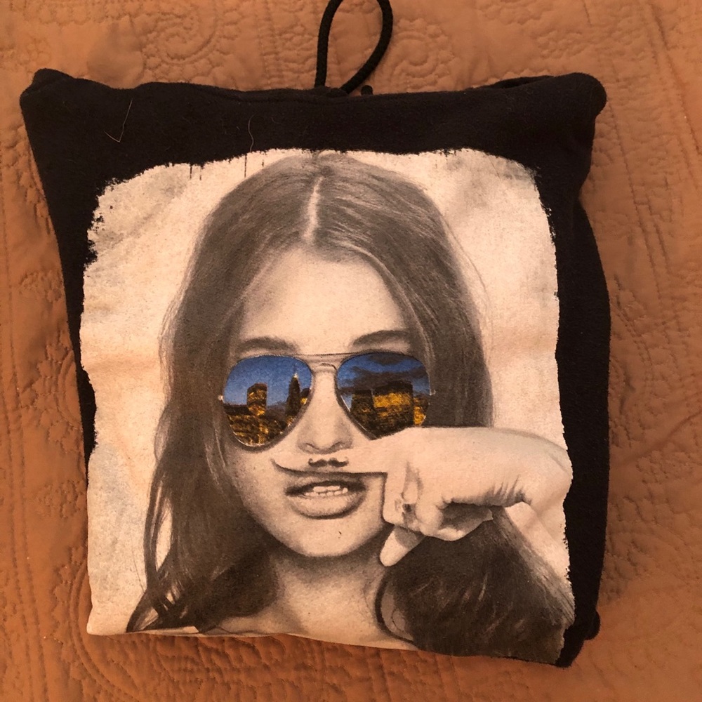 girl with mustache finger sweatshirt
